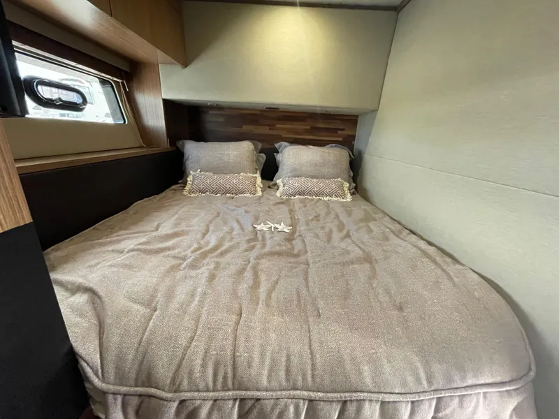 Slide: The Image of Cozy bedroom interior of 2017 Sea Ray L590 Fly yacht with plush bedding. - 32