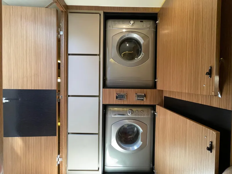 Slide: The Image of Laundry area with washer and dryer in 2017 Sea Ray L590 Fly yacht. - 34