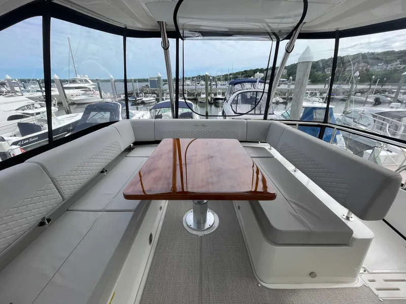 Slide: The Image of Luxurious 2017 Sea Ray L590 Fly yacht interior with elegant seating and wooden table. - 39
