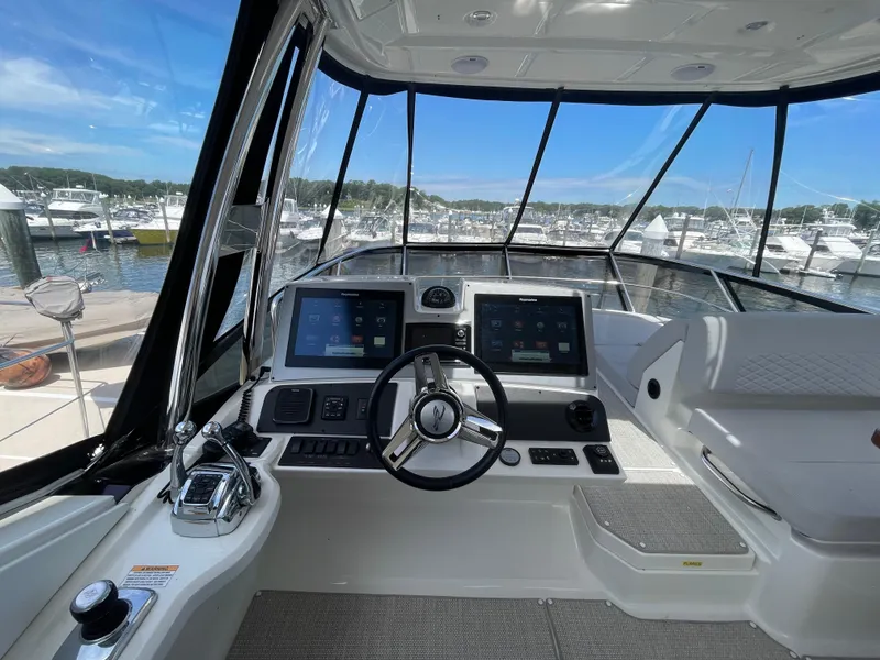 Slide: The Image of Helm of 2017 Sea Ray L590 Fly yacht with modern navigation displays and controls. - 41
