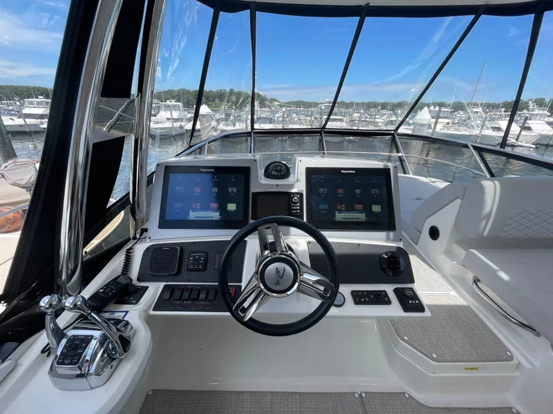 Slide: The Image of Helm of 2017 Sea Ray L590 Fly yacht with dual displays and steering wheel. - 42