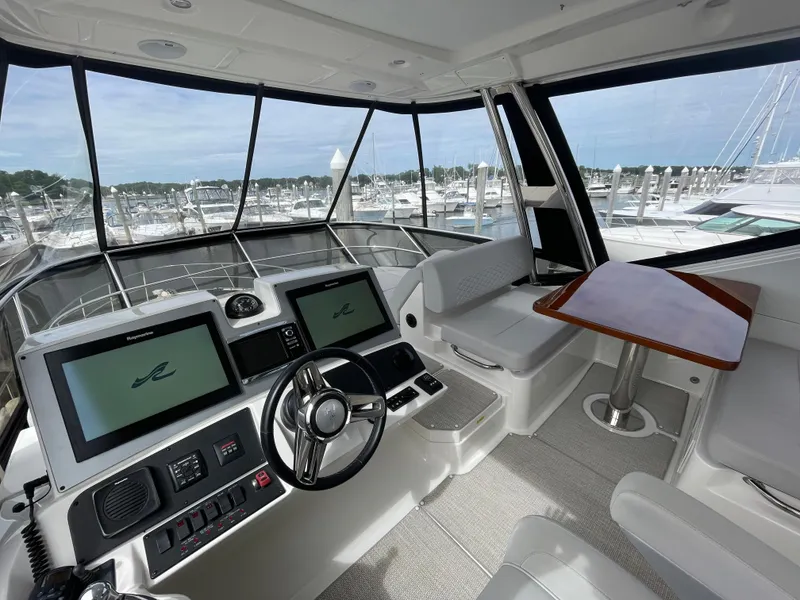 Slide: The Image of 2017 Sea Ray L590 Fly yacht cockpit with modern controls and marina view. - 43