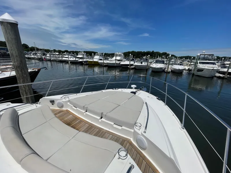 Slide: The Image of 2017 Sea Ray L590 Fly yacht docked at a marina under a clear blue sky. - 47