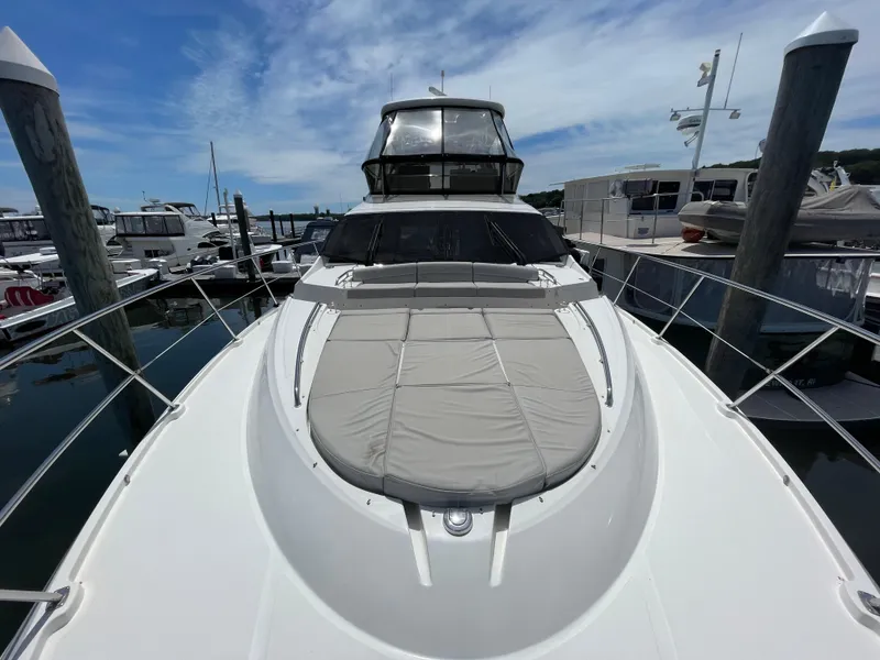 Slide: The Image of 2017 Sea Ray L590 Fly yacht docked at marina under blue sky. - 48
