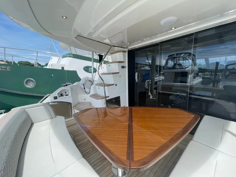 Slide: The Image of Luxurious 2017 Sea Ray L590 Fly yacht with elegant outdoor seating and wooden table. - 7