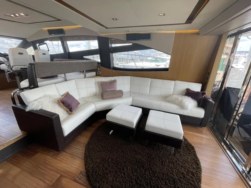 Slide: The Image of Luxurious 2017 Sea Ray L590 Fly yacht interior with white leather seating and plush cushions. - 9