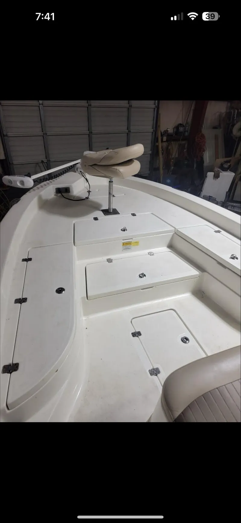Slide: The Image of 2014 NauticStar 244 XTS boat deck with seating and storage compartments. - 2