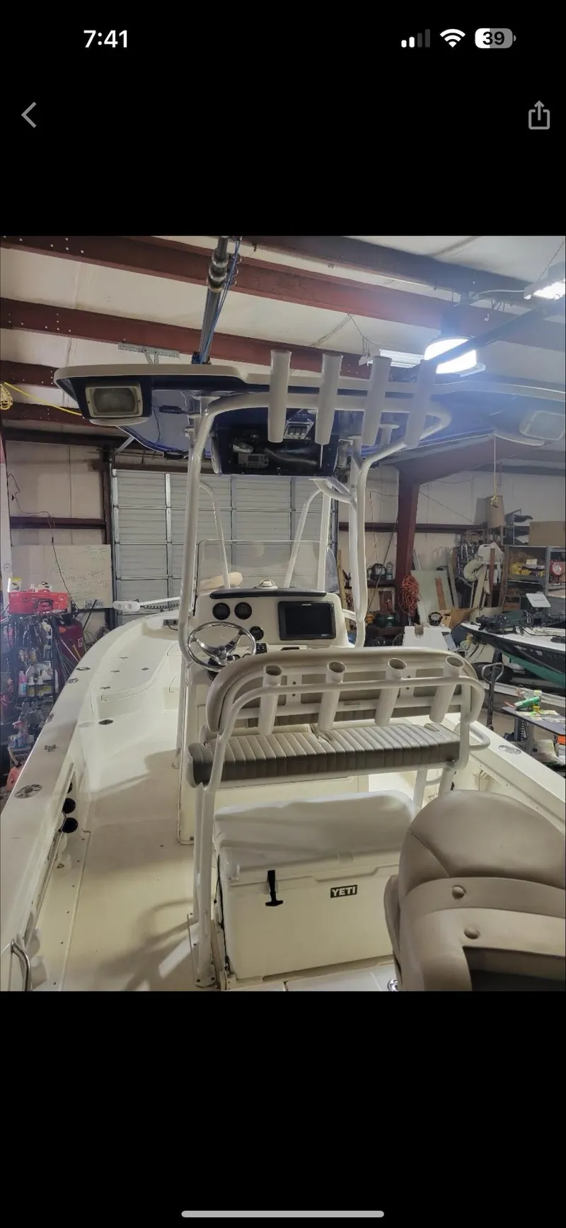 Slide: The Image of 2014 NauticStar 244 XTS boat interior in a garage setting. - 4