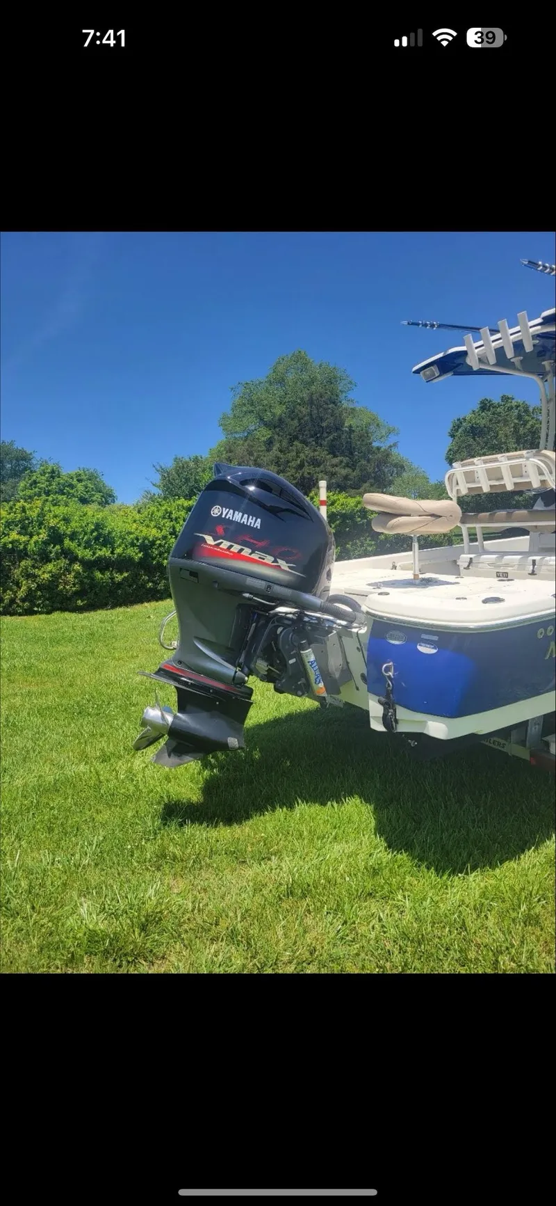 Slide: The Image of 2014 NauticStar 244 XTS boat with Yamaha outboard motor on grassy lawn. - 5
