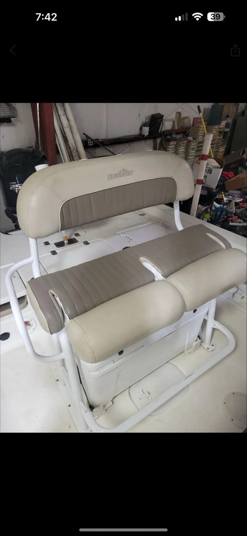 Slide: The Image of 2014 NauticStar 244 XTS boat seat in beige and brown, indoor setting. - 6