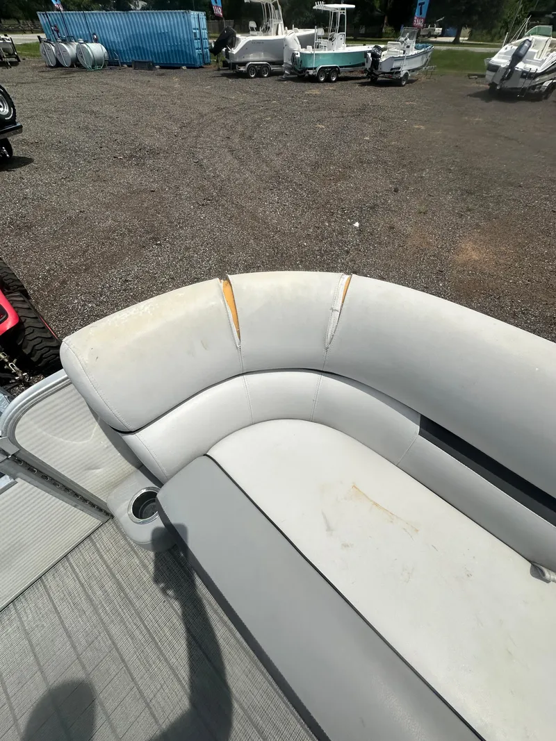 Slide: The Image of 2021 Godfrey SWEETWATER 2186 SB boat seat with visible wear and tears. - 15