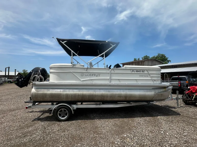 Slide: The Image of 2021 Godfrey SWEETWATER 2186 SB pontoon boat on trailer, parked outdoors. - 6