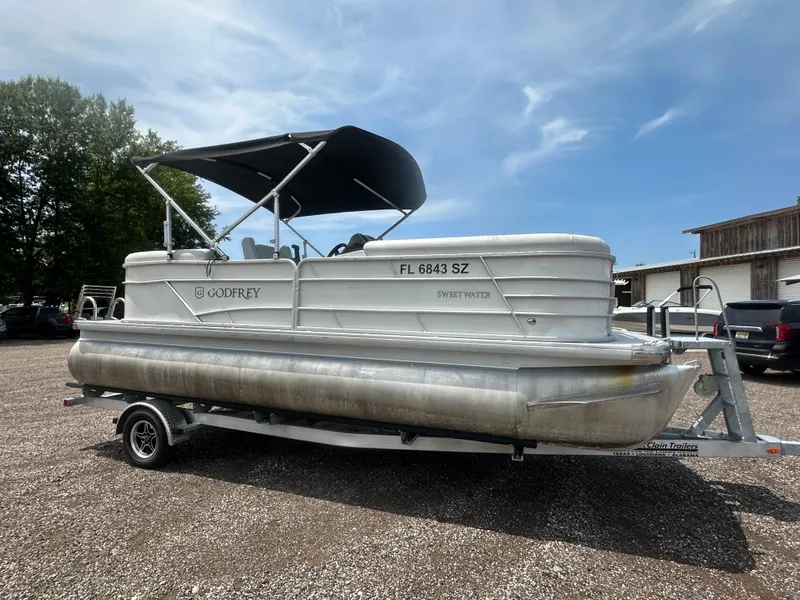 Slide: The Image of 2021 Godfrey SWEETWATER 2186 SB pontoon boat on trailer, parked outdoors. - 7