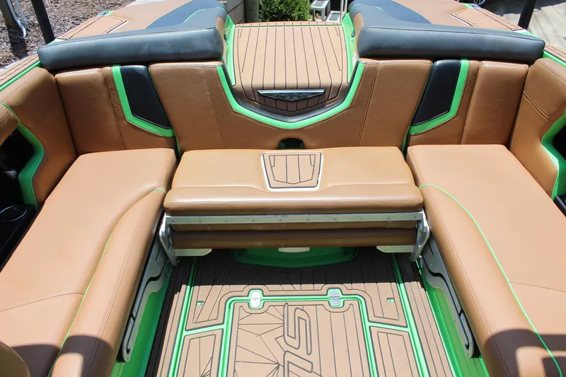 Slide: The Image of 2017 Nautique Super Air G23 interior with tan and green seating, showcasing luxury design. - 11