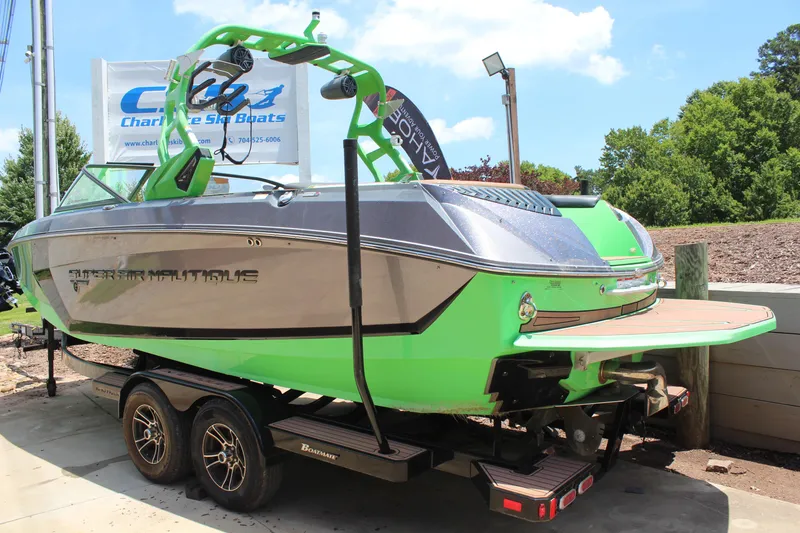 Slide: The Image of 2017 Nautique Super Air G23 boat with vibrant green accents on a trailer. - 2
