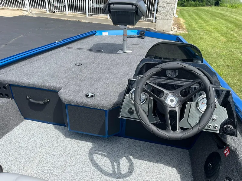 Slide: The Image of 2026 Lund 1775 Renegade SS boat interior with steering wheel and seating area. - 10