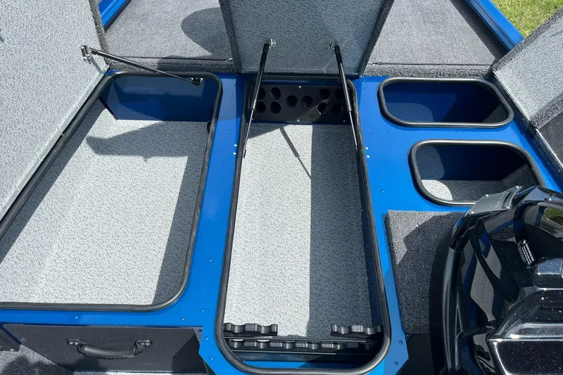 Slide: The Image of 2026 Lund 1775 Renegade SS boat interior with storage compartments and blue accents. - 11