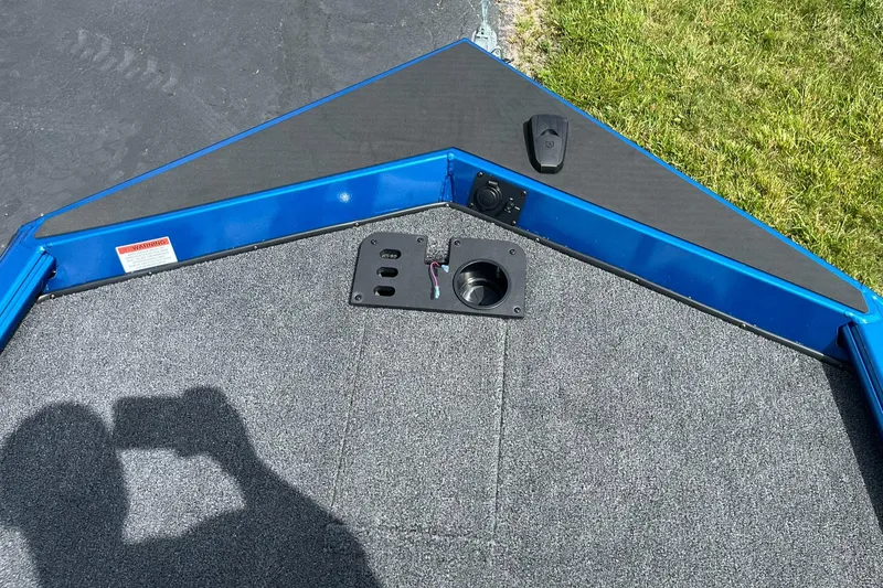 Slide: The Image of 2026 Lund 1775 Renegade SS boat deck with blue trim and carpeted surface. - 12