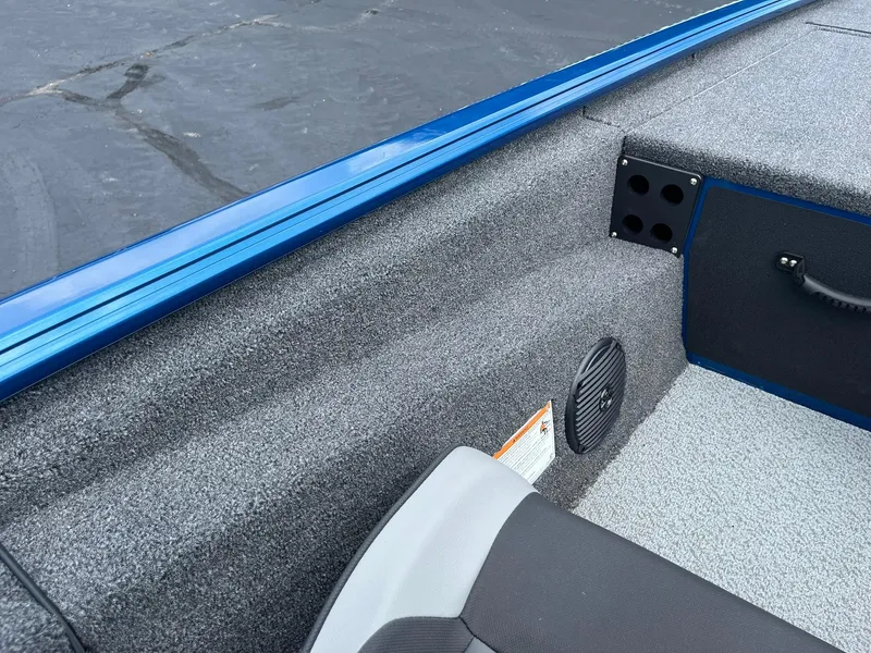 Slide: The Image of Interior of 2026 Lund 1775 Renegade SS boat, featuring gray carpet and blue trim. - 14