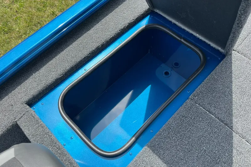 Slide: The Image of 2026 Lund 1775 Renegade SS boat storage compartment, blue interior, open lid. - 16