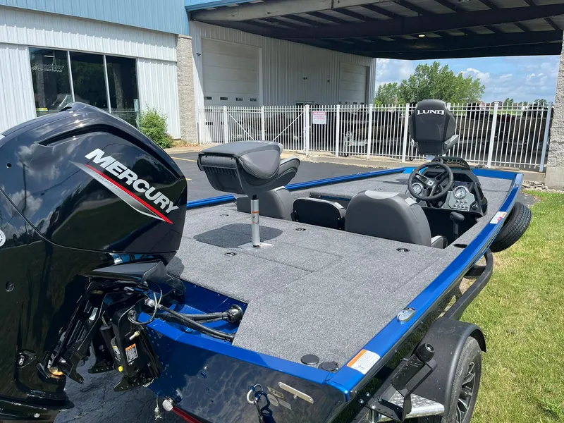 Slide: The Image of 2026 Lund 1775 Renegade SS boat with Mercury engine, parked outdoors. - 3