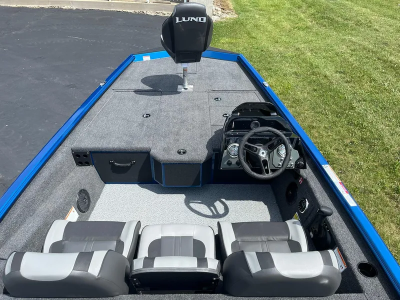 Slide: The Image of 2026 Lund 1775 Renegade SS boat interior with steering wheel and seating. - 5