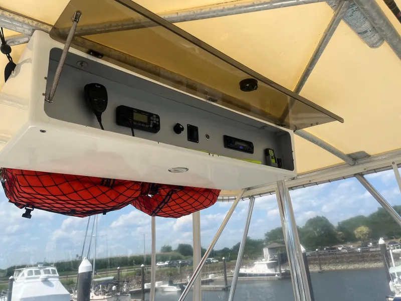 Slide: The Image of 1987 Tiara Yachts 3600 cockpit with radio equipment and life jackets, marina view. - 12