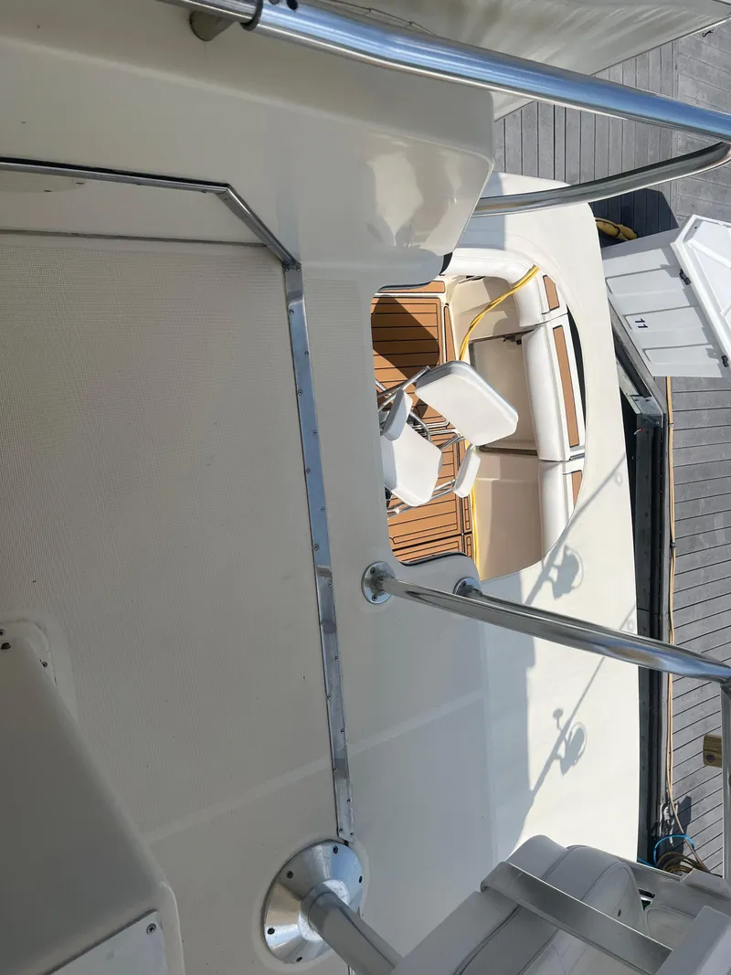 Slide: The Image of 1987 Tiara Yachts 3600 interior with white seating and wooden accents. - 13