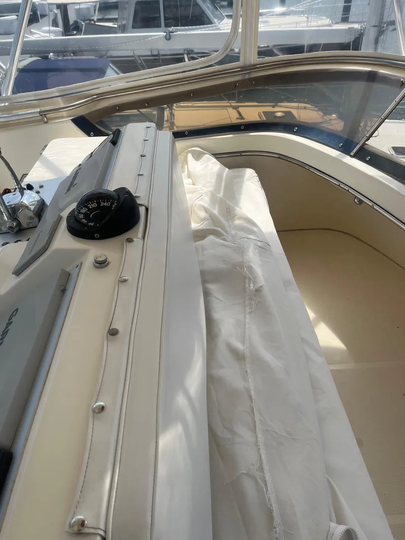 Slide: The Image of 1987 Tiara Yachts 3600 interior with compass and white seating area. - 14