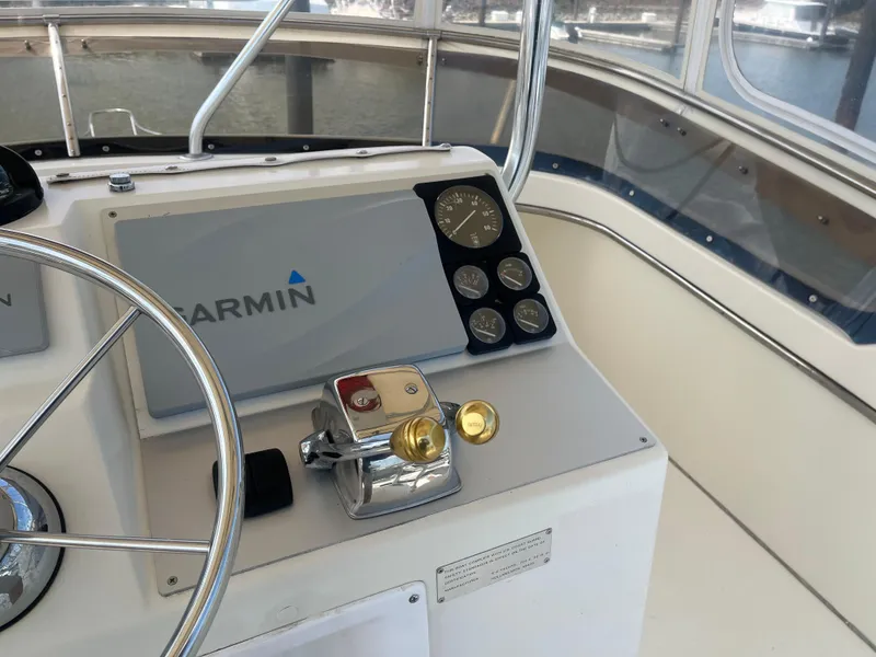 Slide: The Image of 1987 Tiara Yachts 3600 helm with Garmin navigation and control panel. - 15