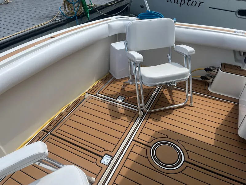 Slide: The Image of 1987 Tiara Yachts 3600 boat deck with white chair and teak flooring. - 21