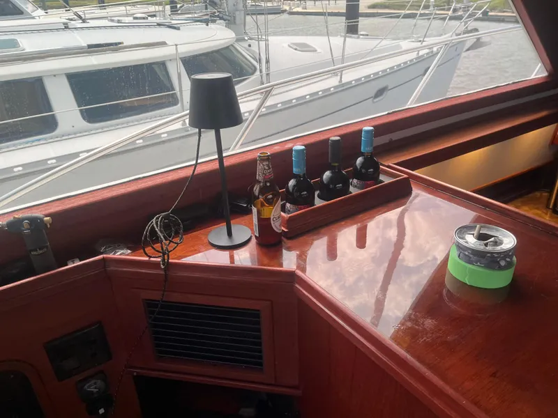 Slide: The Image of Interior of 1987 Tiara Yachts 3600 with wine bottles and lamp on wooden surface. - 23