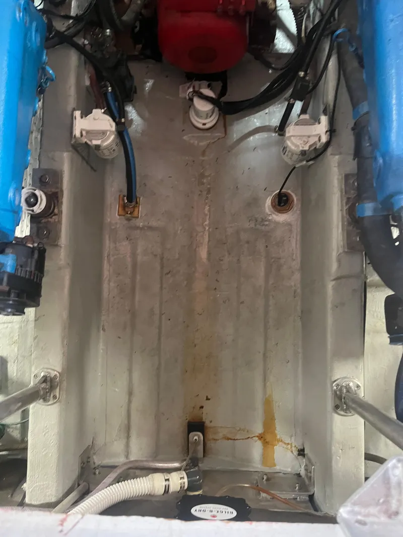 Slide: The Image of Engine compartment of a 1987 Tiara Yachts 3600, showing mechanical components and wiring. - 24