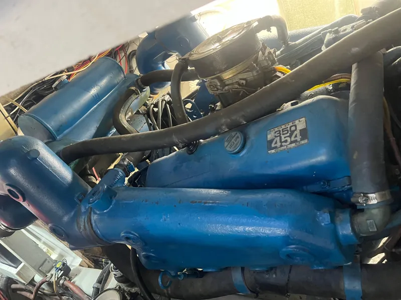 Slide: The Image of Engine of a 1987 Tiara Yachts 3600, featuring a blue Model 454 engine. - 25
