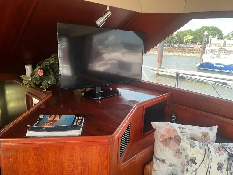 Slide: The Image of Interior of 1987 Tiara Yachts 3600 with TV, floral pillows, and magazines. - 27