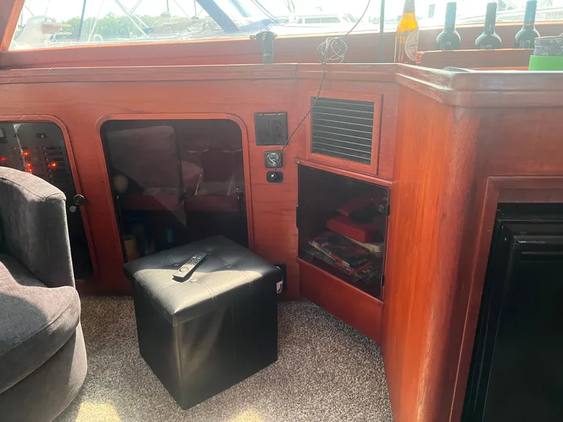 Slide: The Image of 1987 Tiara Yachts 3600 interior with wood paneling, storage, and seating. - 29