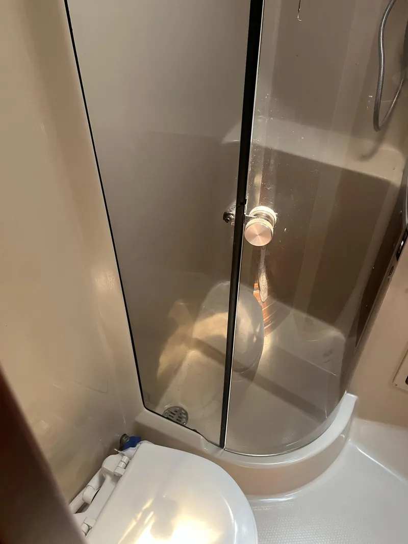 Slide: The Image of Bathroom interior of a 1987 Tiara Yachts 3600, featuring a shower and toilet. - 32