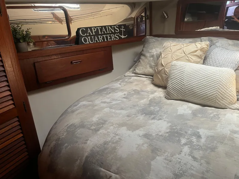 Slide: The Image of Cozy cabin interior of 1987 Tiara Yachts 3600 with decorative pillows and "Captain's Quarters" sign. - 33