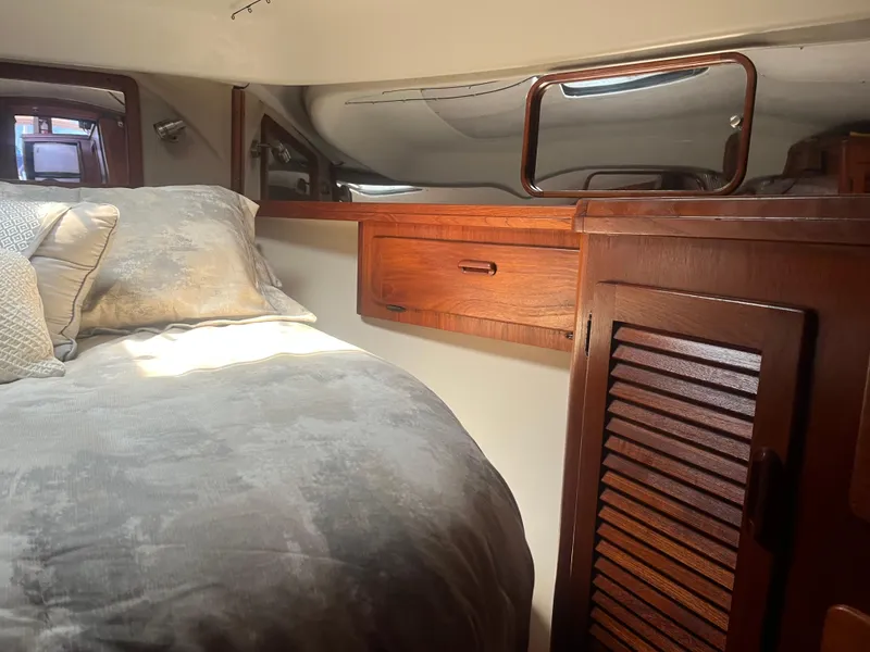 Slide: The Image of Cozy cabin interior of 1987 Tiara Yachts 3600 with wooden cabinetry and plush bedding. - 35