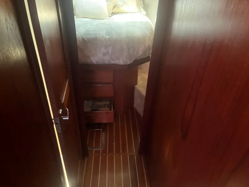 Slide: The Image of 1987 Tiara Yachts 3600 interior with wooden flooring and cozy bed. - 36