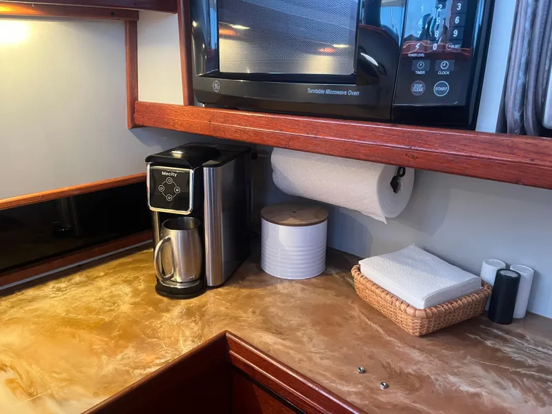 Slide: The Image of 1987 Tiara Yachts 3600 galley with microwave, coffee maker, and countertop essentials. - 39