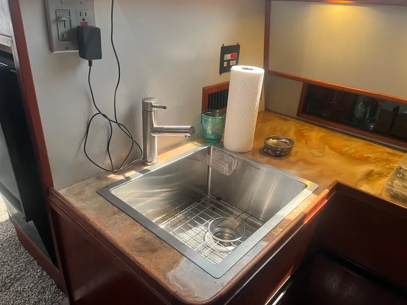 Slide: The Image of 1987 Tiara Yachts 3600 galley sink with modern faucet and countertop accessories. - 40