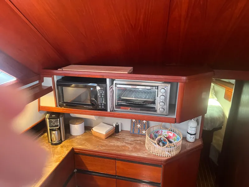 Slide: The Image of 1987 Tiara Yachts 3600 galley with microwave, toaster oven, and coffee maker. - 42