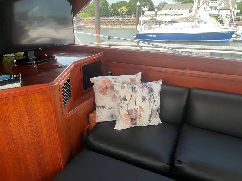 Slide: The Image of Interior of 1987 Tiara Yachts 3600 with floral cushions and black seating. - 43