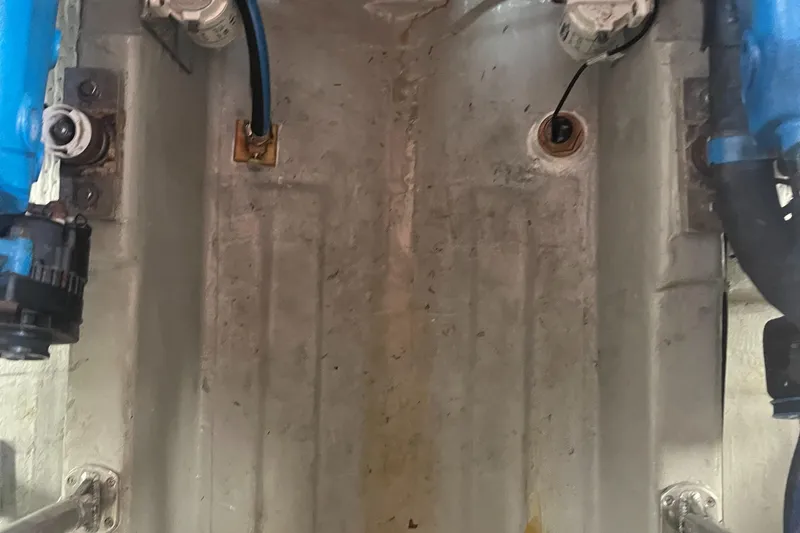 Slide: The Image of Engine compartment of a 1987 Tiara Yachts 3600, showing mechanical components and wiring. - 44