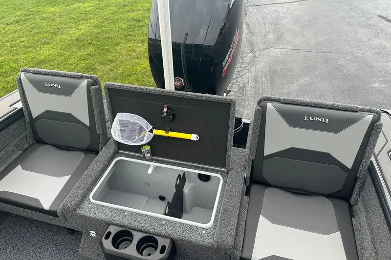 Slide: The Image of 2026 Lund 1775 Crossover XS boat interior with seating and storage compartments. - 11