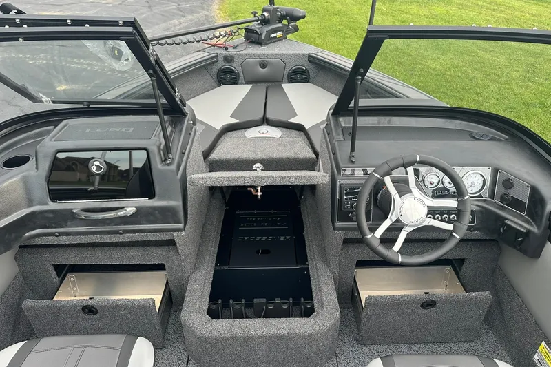 Slide: The Image of 2026 Lund 1775 Crossover XS boat interior with steering wheel and dashboard controls. - 13