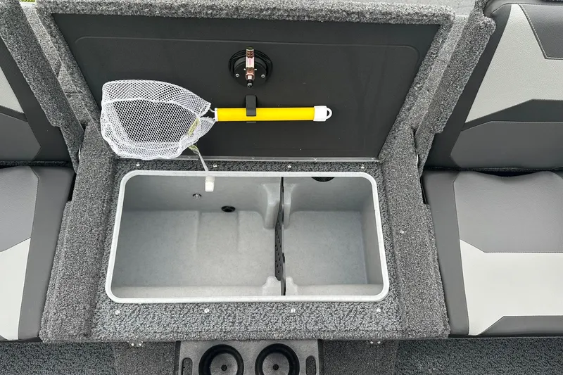 Slide: The Image of 2026 Lund 1775 Crossover XS boat interior with storage compartment and fishing net. - 15