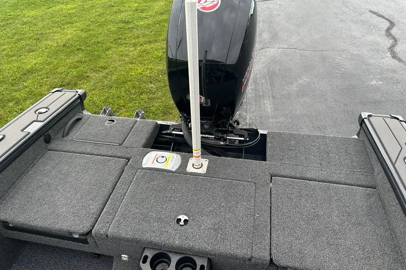 Slide: The Image of 2026 Lund 1775 Crossover XS boat with motor, featuring spacious deck and storage compartments. - 17