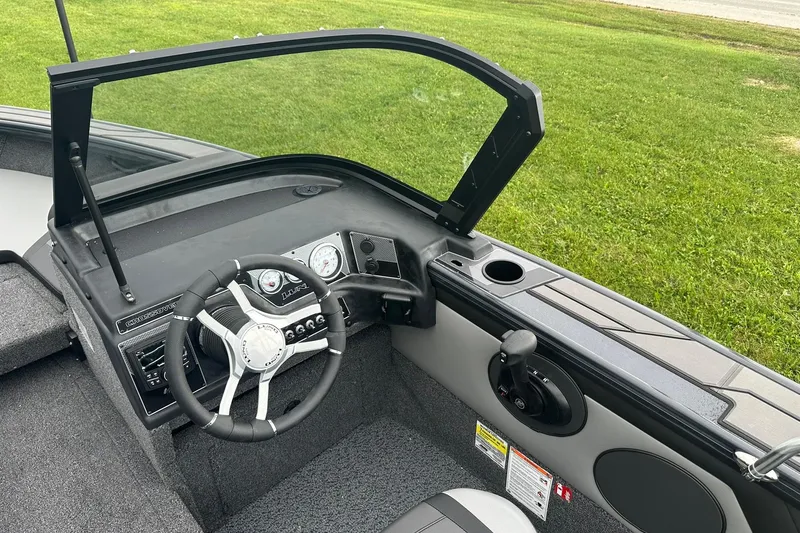 Slide: The Image of 2026 Lund 1775 Crossover XS boat interior with steering wheel and dashboard. - 22